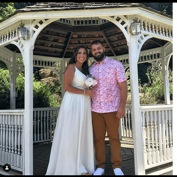 couple standing together at gazebo